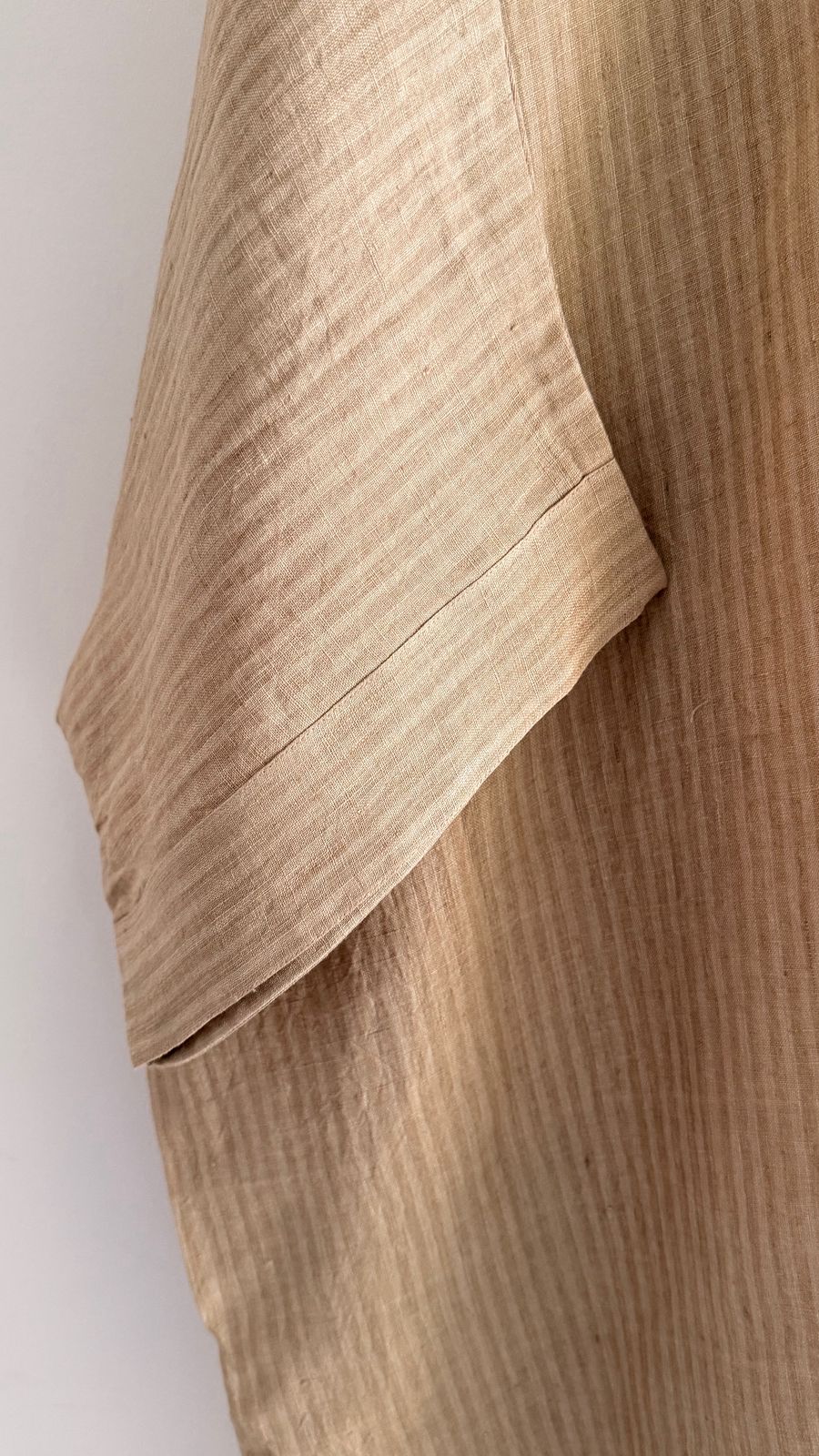 Sycamore dress in Kora Sand – close-up of wide sleeve in textured handwoven linen.