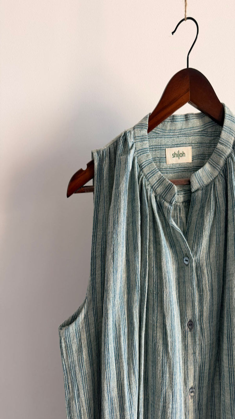 Sleeveless handwoven cotton striped top in blue with button-down front.