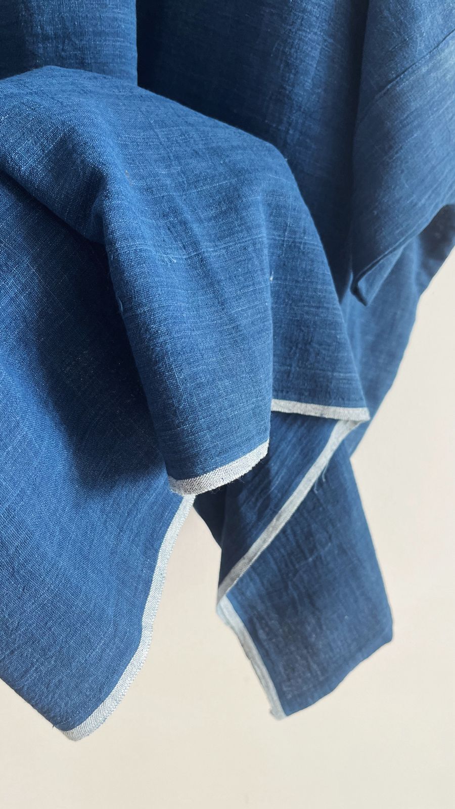 Detail shot of indigo khadi fabric and soft raw edge finish on the Cedar Dress sleeve