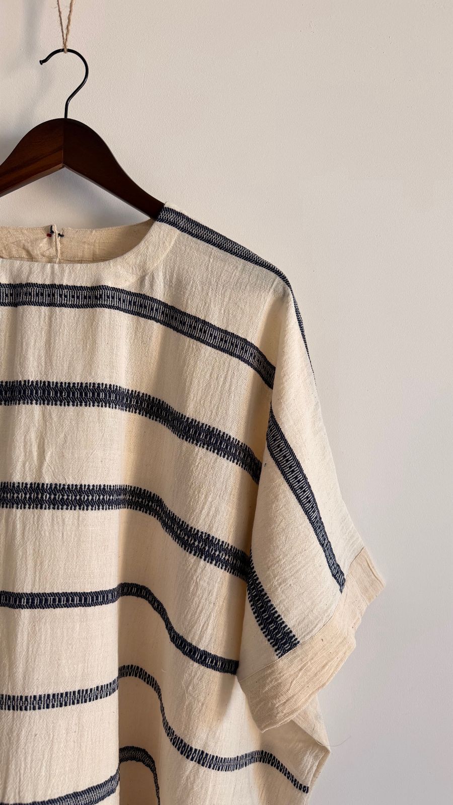 Close-up of Cedar Dress in ivory handwoven cotton with ink stripe detailing and relaxed sleeve finish