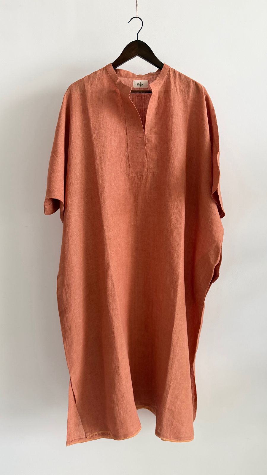 Loose silhouette tangerine linen dress with short sleeves and clean front slit neckline
