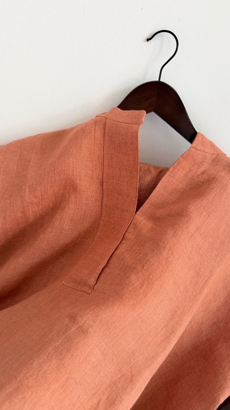 Handwoven tangerine linen dress with a soft band collar and minimal placket detail