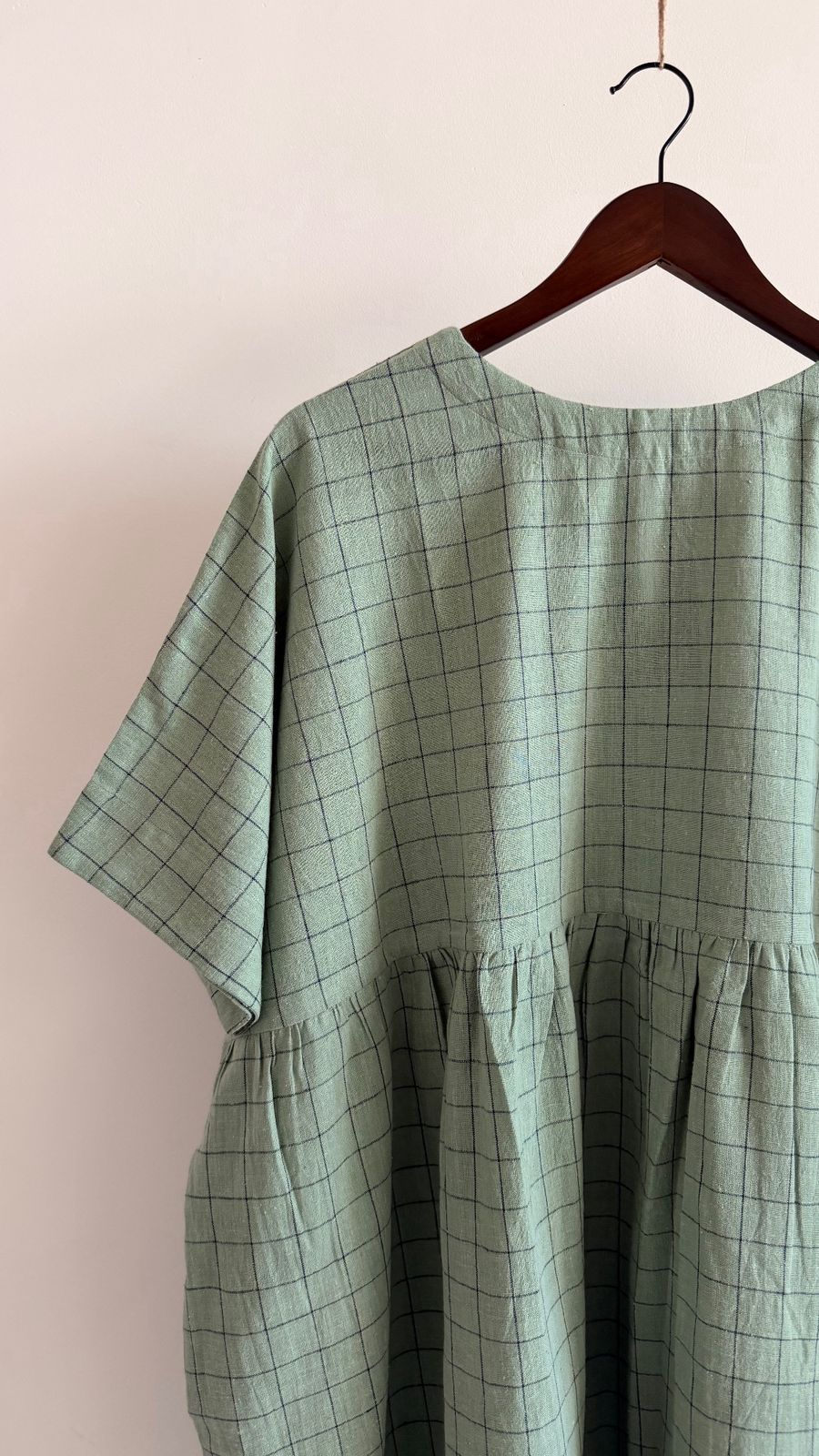 Close-up of gathered waist and soft drape in textured cotton fabric
