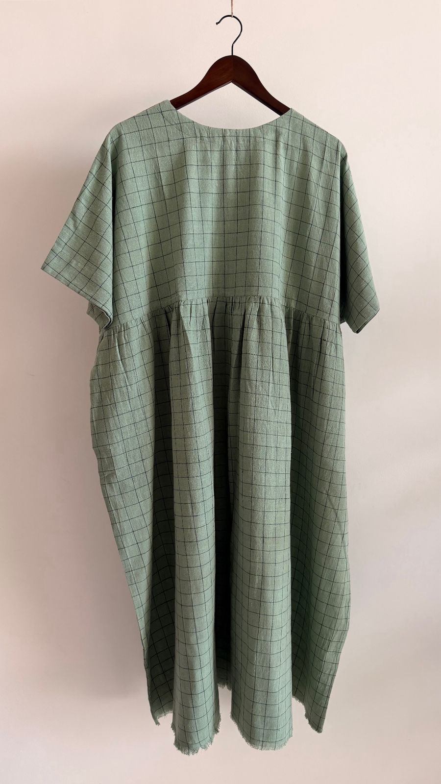 Full-length view of airy pale teal dress with loose silhouette