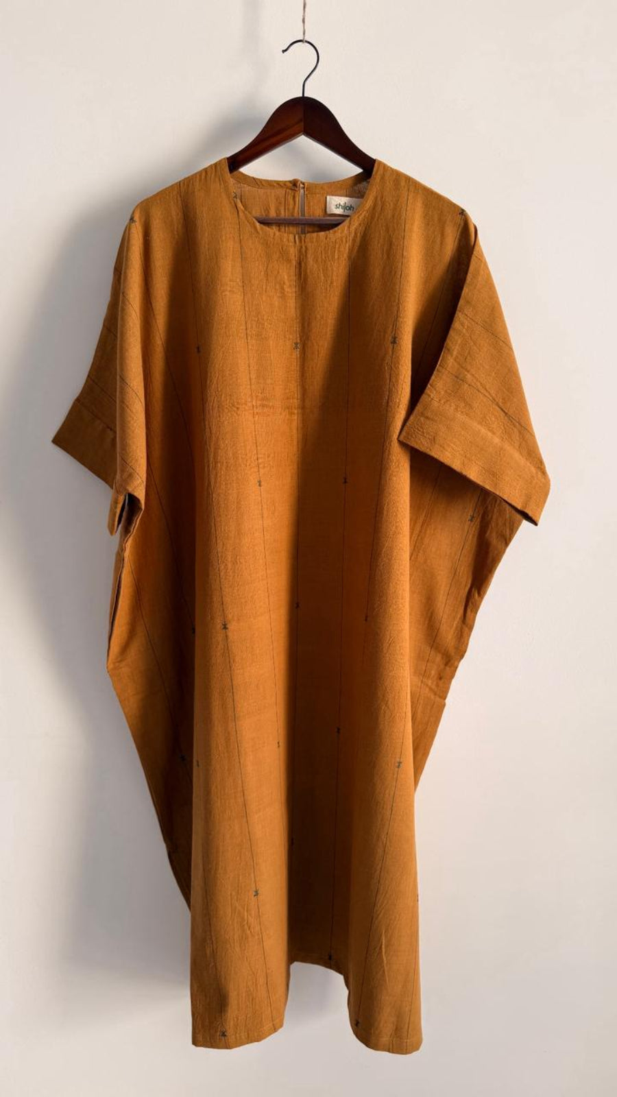 Handwoven cotton dress in amber pine with wide short sleeves, front view