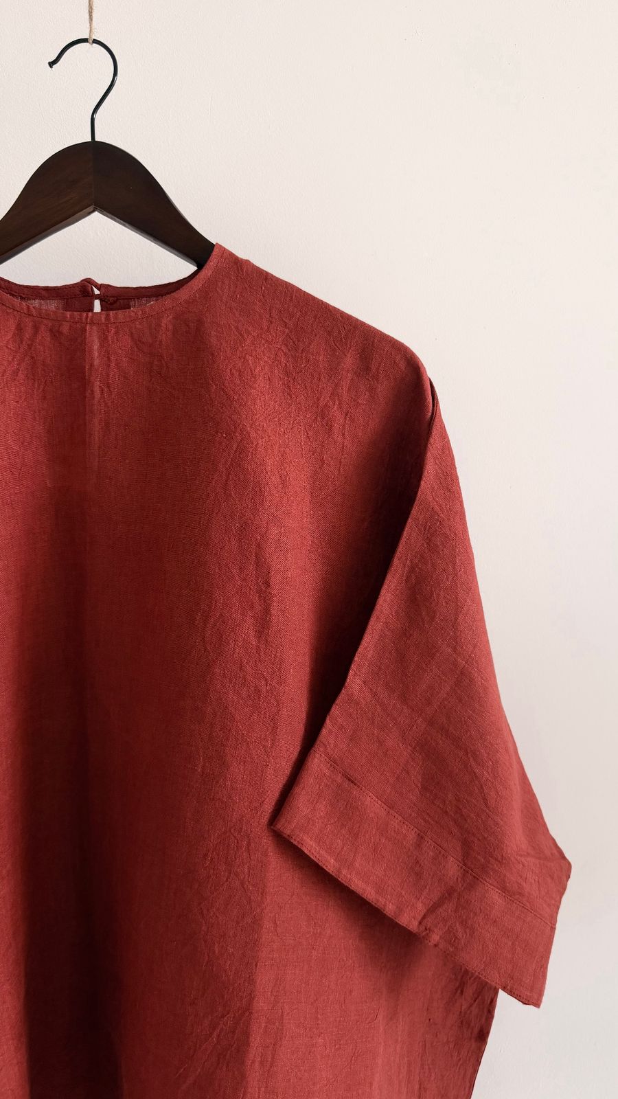Relaxed fit linen top in burnt berry with clean neckline and subtle structure