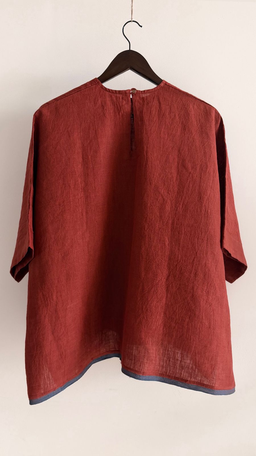 Breathable handwoven linen top in muted red tone, soft drape and natural texture