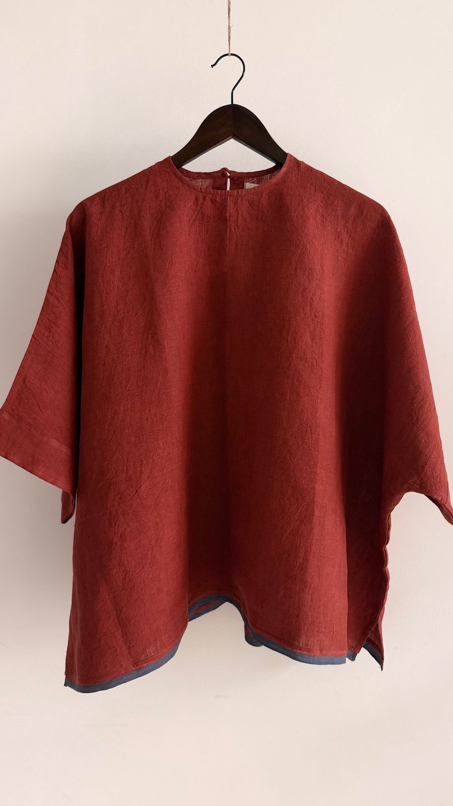 Sustainable handcrafted linen top in earthy red shade, lightweight and airy