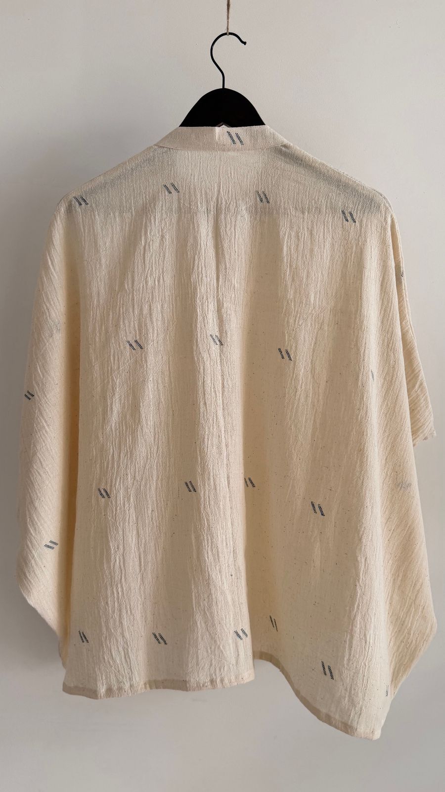 Back view of undyed cotton top with soft drape and textured weave