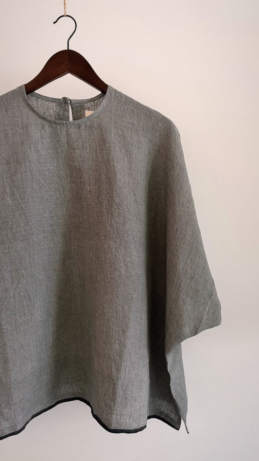 Elm top in ash grey handwoven linen with a black contrast hem, featuring a relaxed oversized silhouette and wide sleeves.