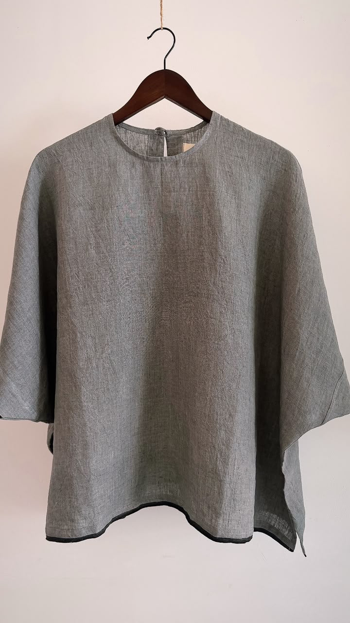 Minimal oversized linen top in ash grey with a black hem, crafted from breathable handwoven linen.