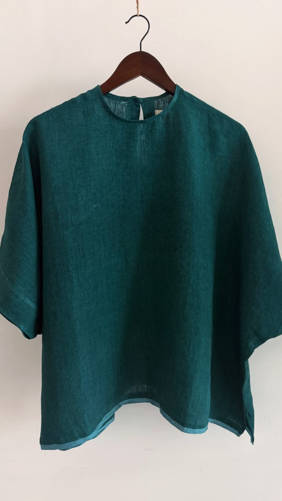 Oversized forest green linen top with wide sleeves, crafted from airy handwoven linen for everyday comfort.