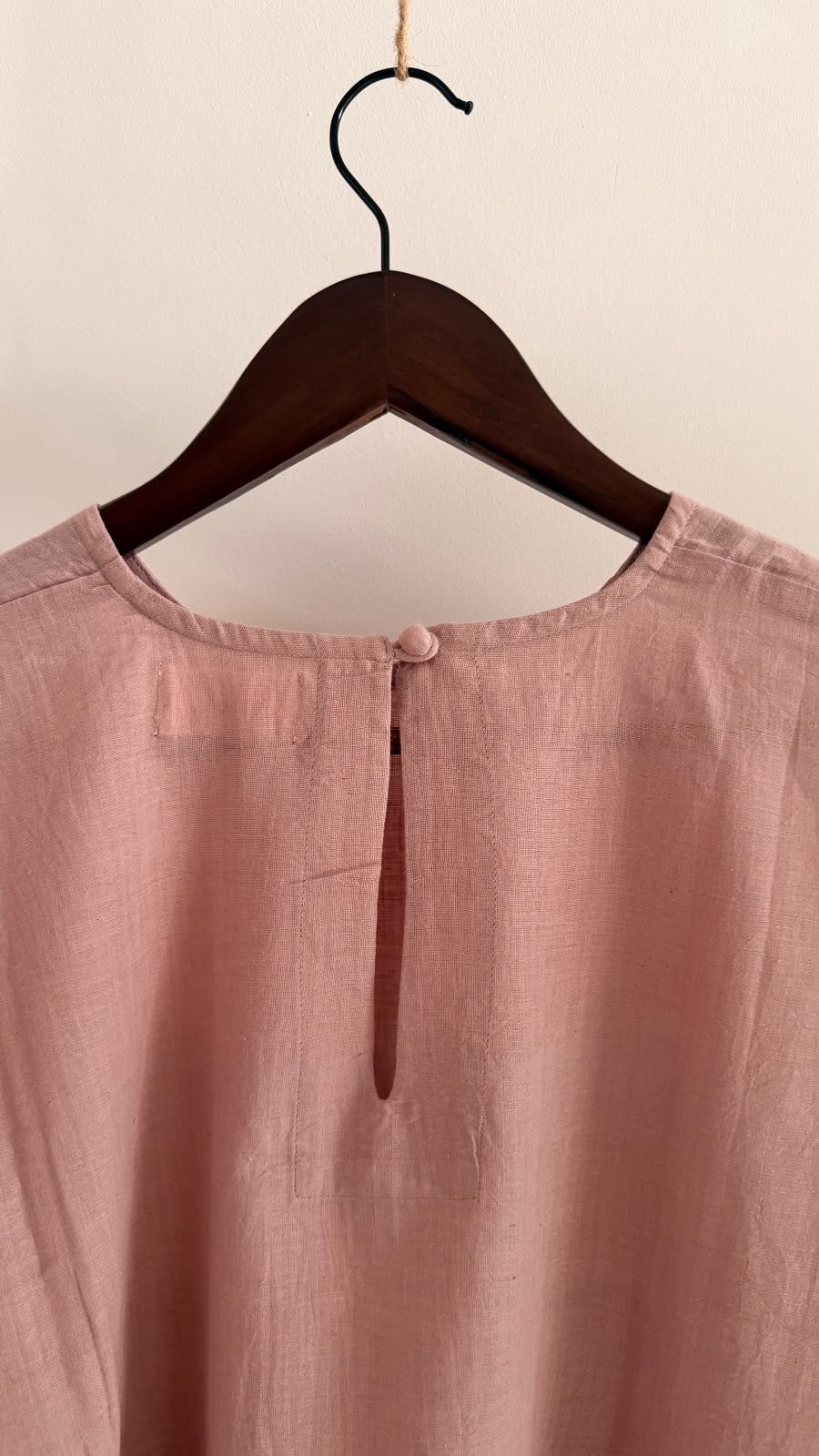 Close-up of the Rue top showing the back button closure and handwoven cotton fabric.