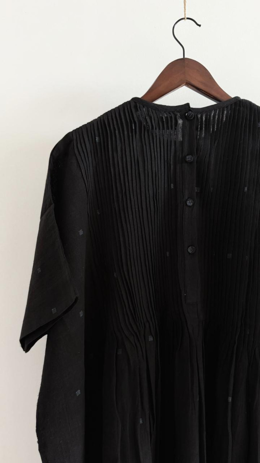 Back view of Balm Coal Sky black khadi dress with Jamdani motifs and button opening