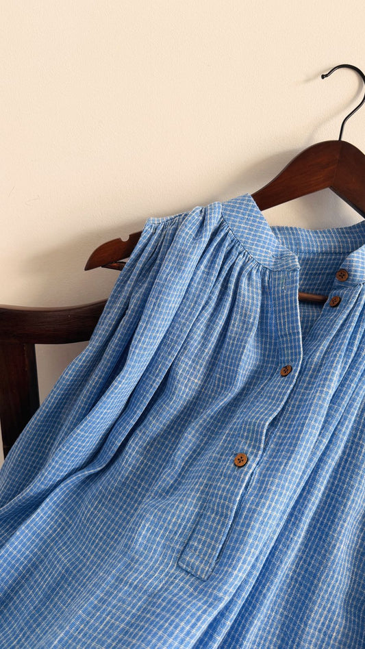Handwoven blue check cotton dress, featuring yoke gathers and wooden button details.