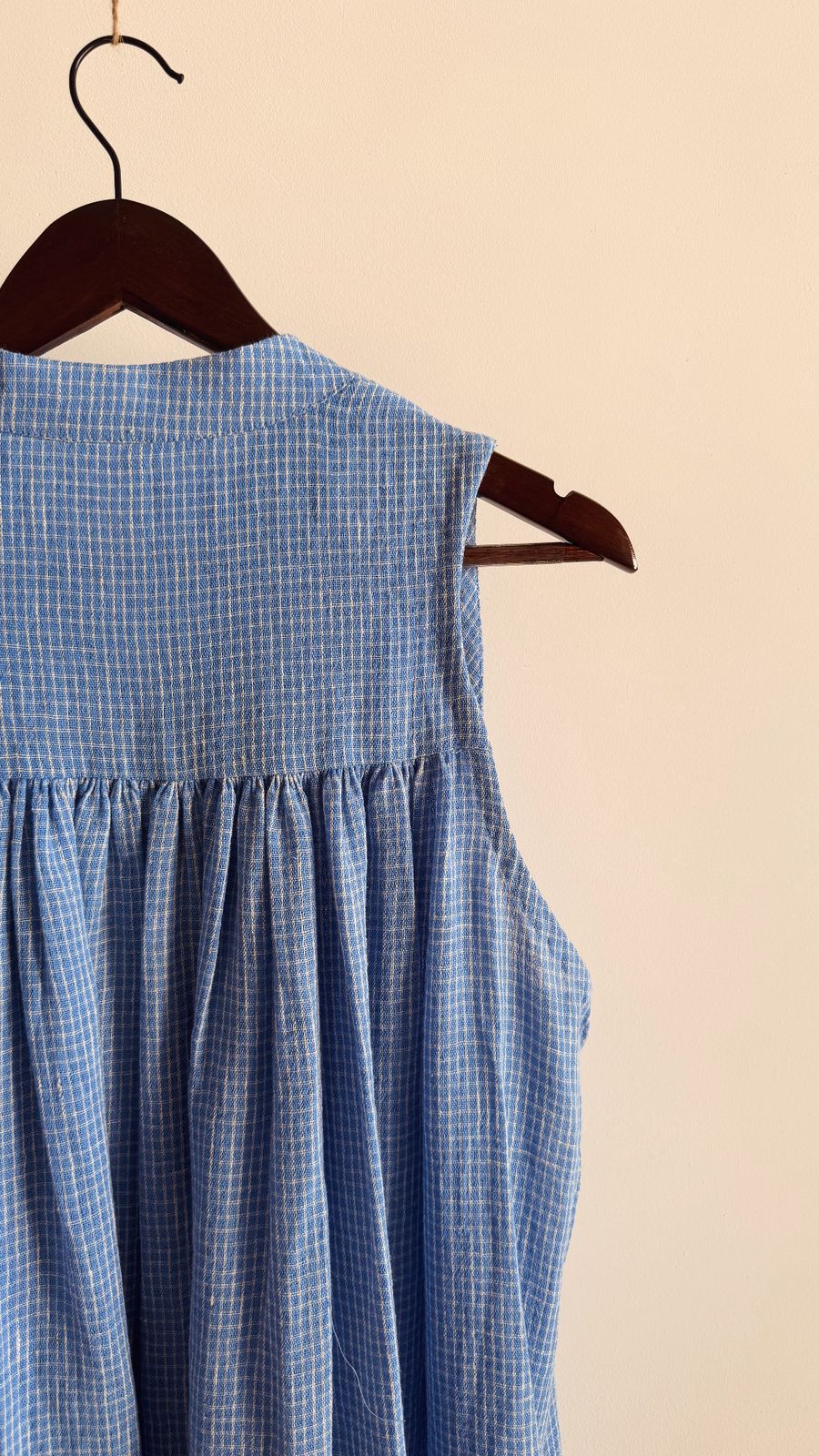 Handwoven blue check cotton dress, featuring yoke gathers and wooden button details.